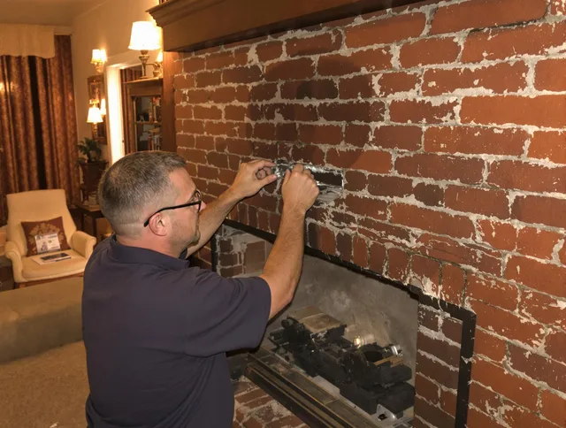 Reynoldsburg Chimney Sweep expert fixing a fireplace in Reynoldsburg, OH